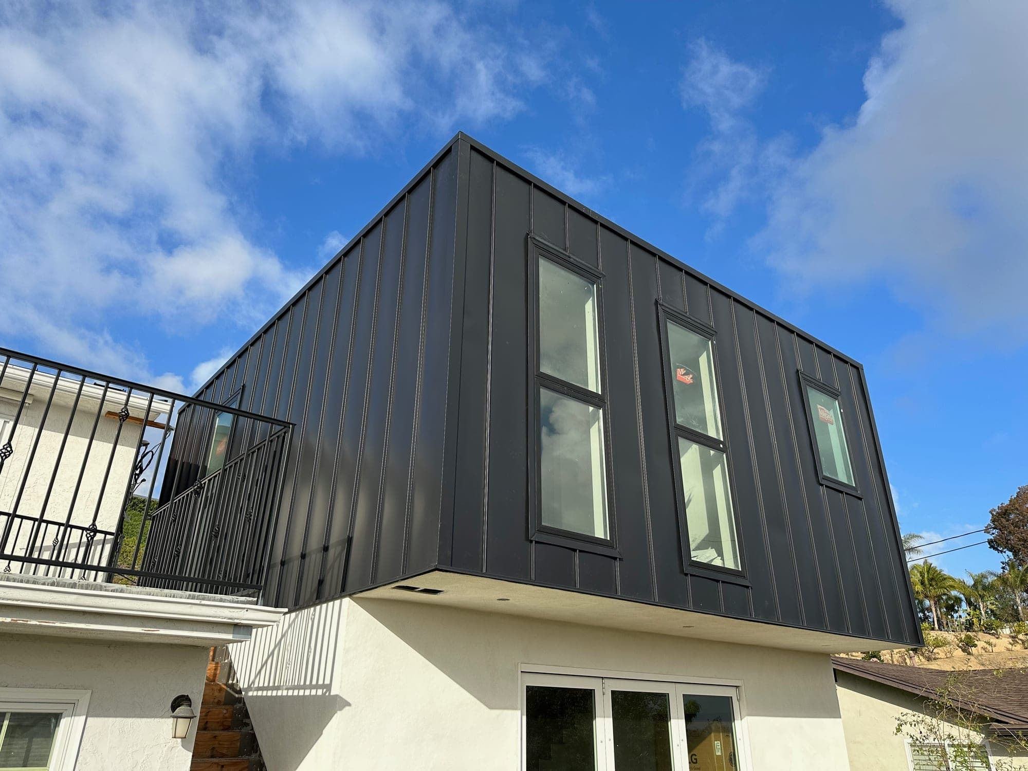 Modern San Diego home with a dark standing seam metal roof