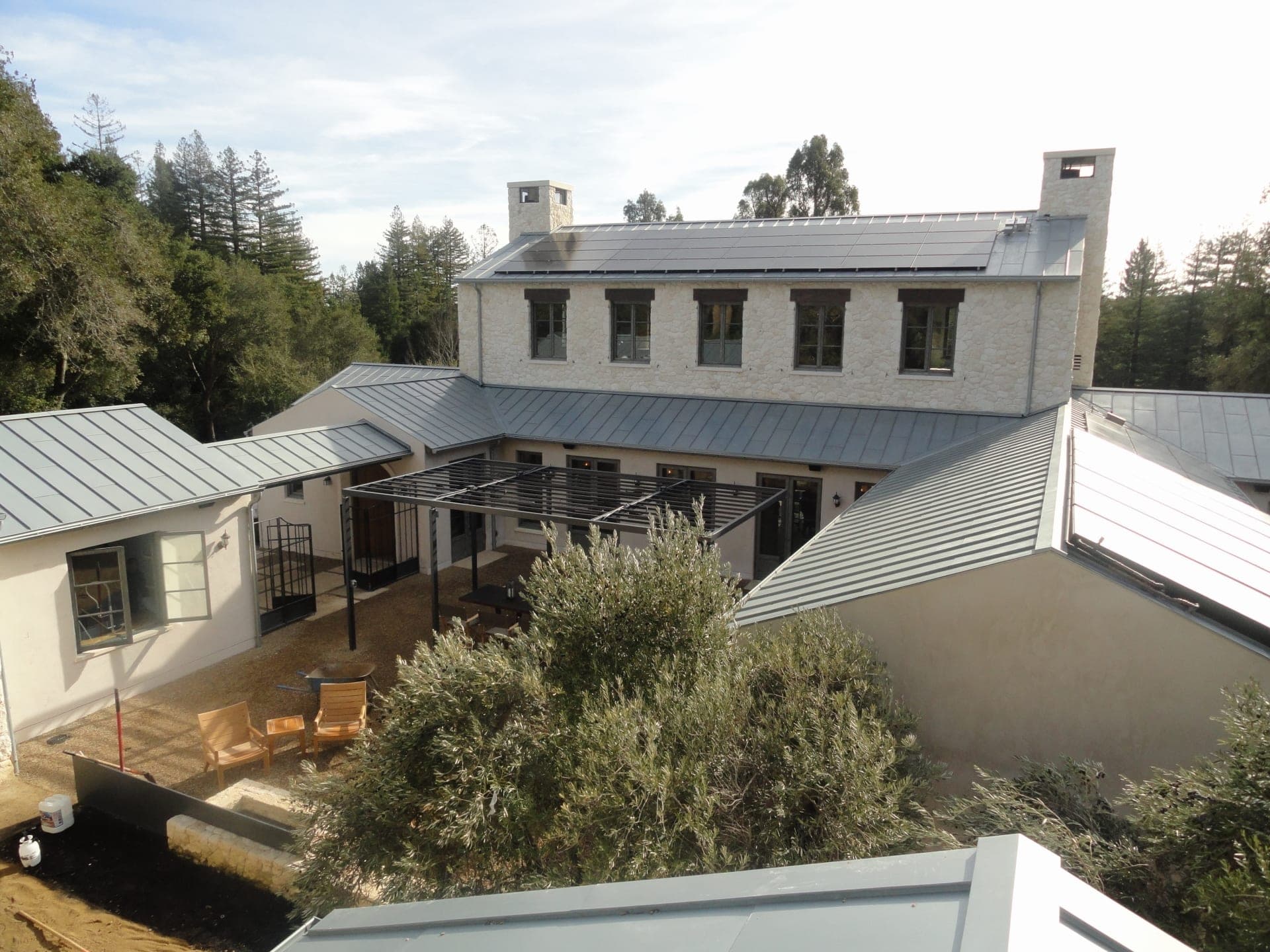 Clean standing seam metal roof on a white San Diego home